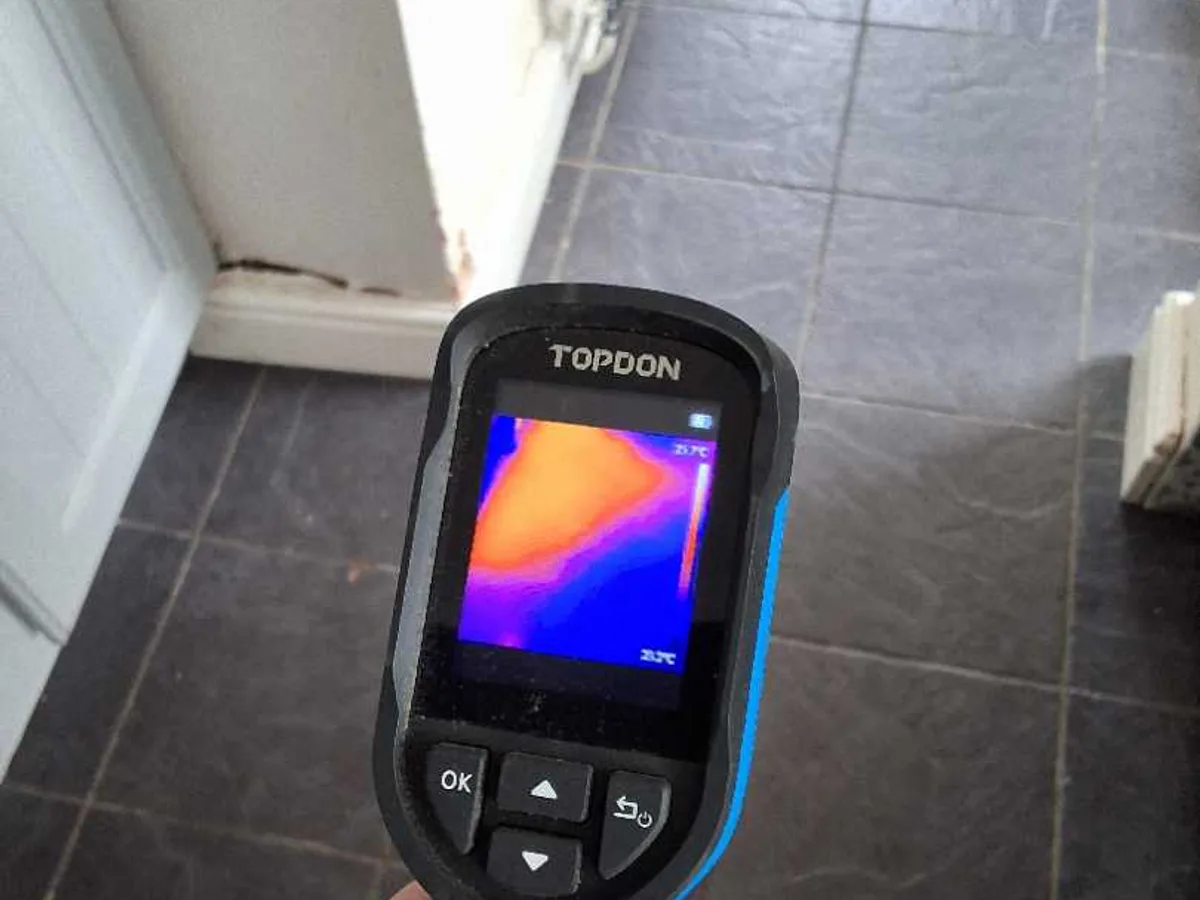 thermal imaging camera displaying warm zone across hallway floor during leak detection survey