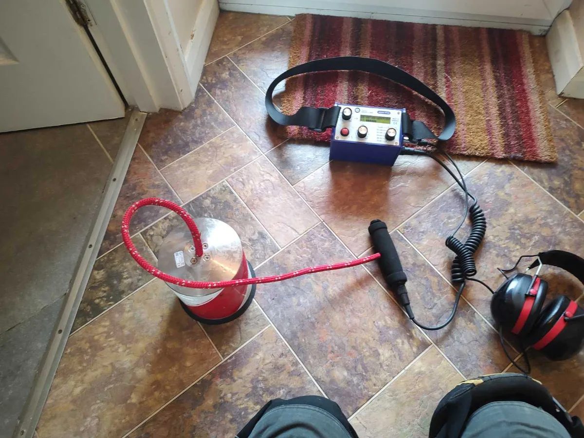 acoustic listening equipment and pressure testing kit on lobby floor during leak detection