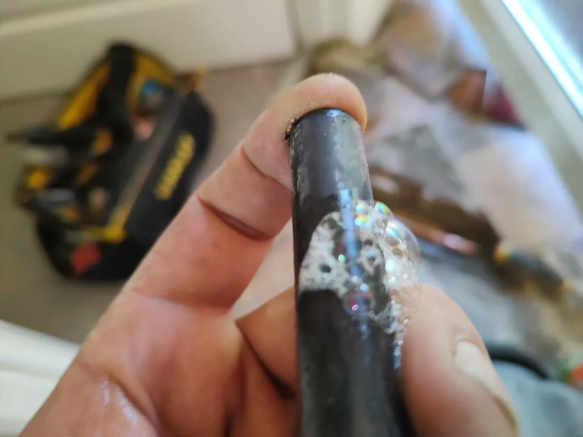 leak found at hairline crack on corroded 15mm copper hot water pipe