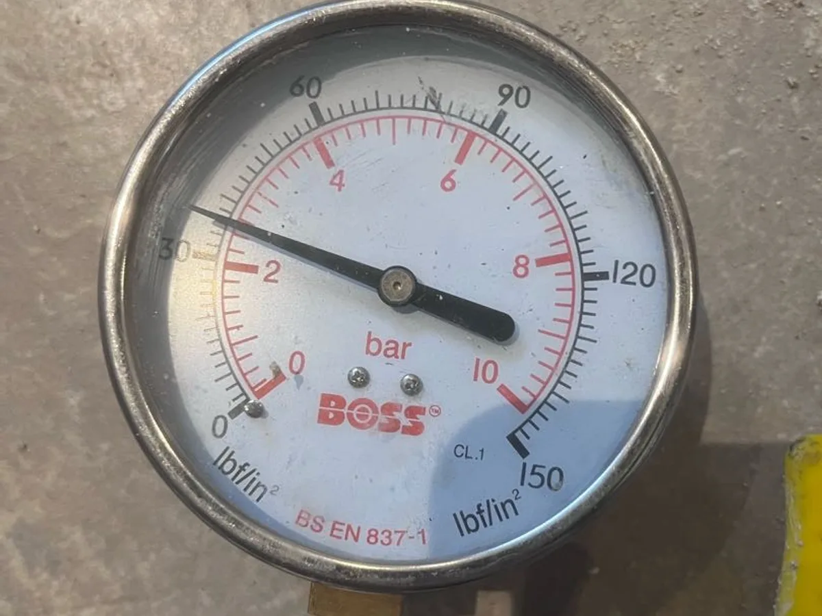 pressure gauge reading approximately two bar on hot water pipework during leak detection