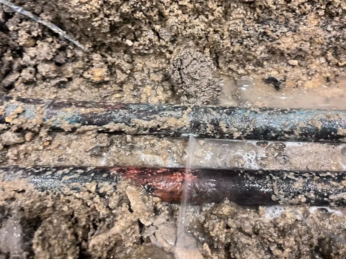 leak identified at unprotected copper pipe laid directly in concrete screed with no insulation