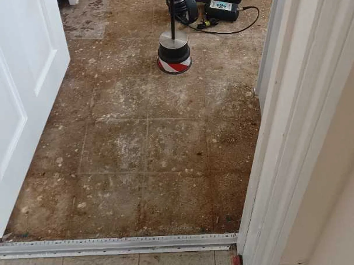acoustic listening equipment with ground microphone on concrete corridor floor during leak detection