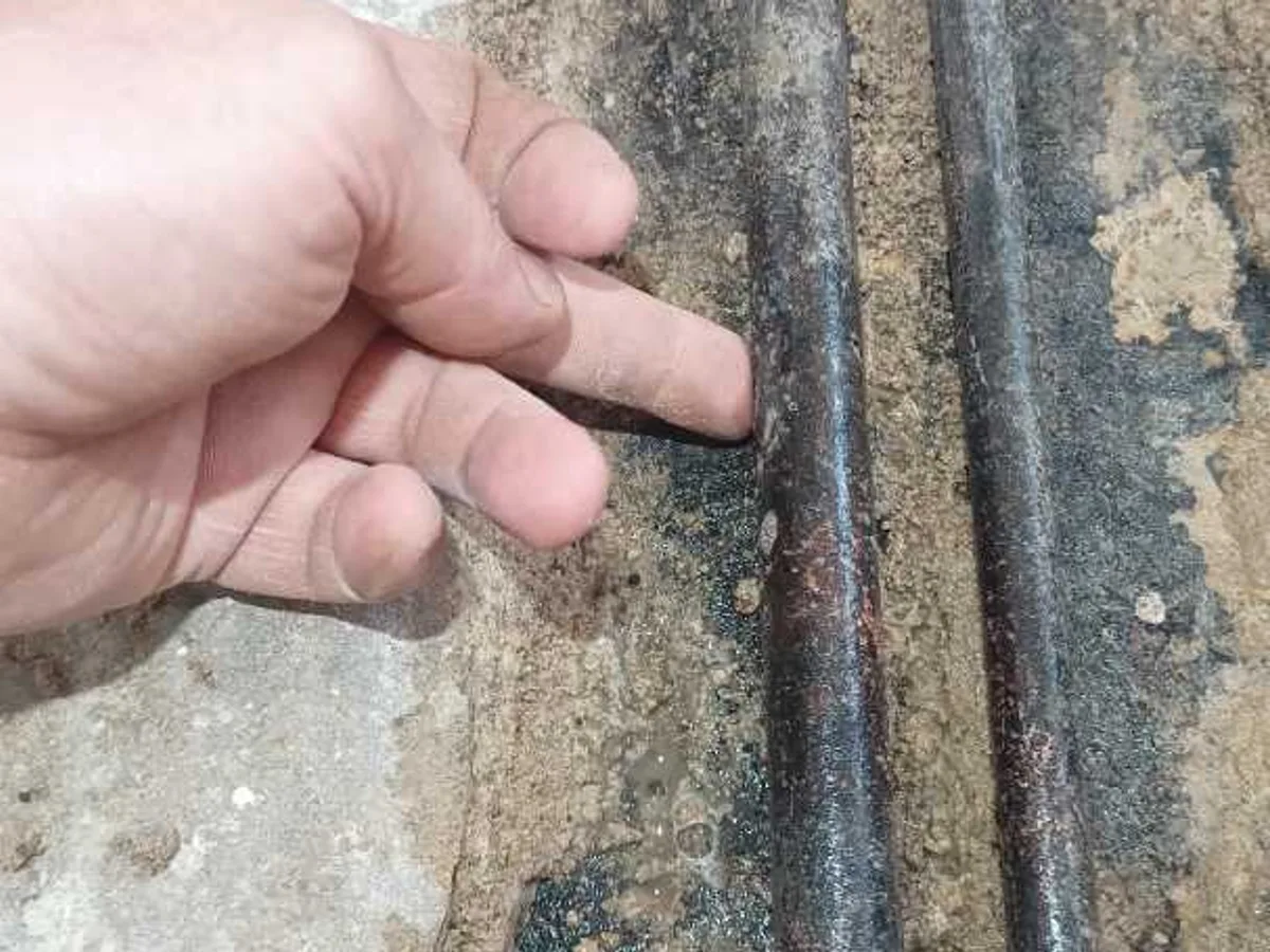 leak located at corroded three-quarter inch copper pipework exposed beneath concrete bedroom floor