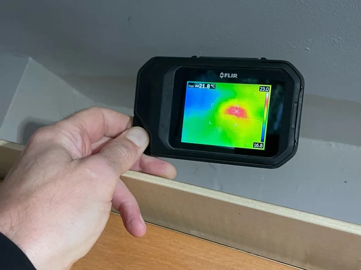 thermal imaging camera showing heat patch on kitchen ceiling during leak detection survey
