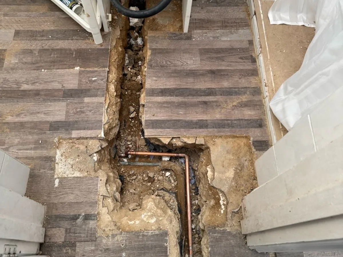 replacement copper pipework installed in excavated toilet floor repair completed