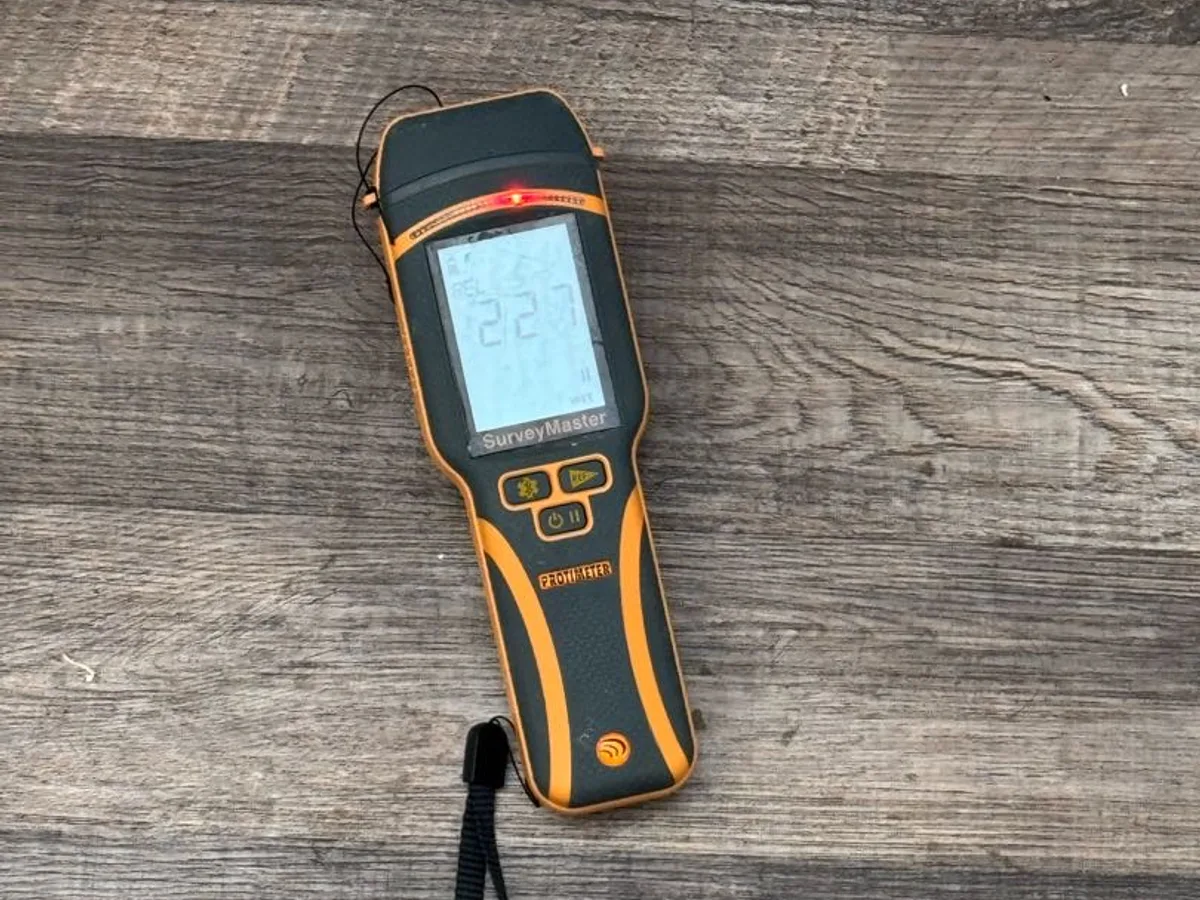 moisture metre reading on wet floor during leak detection survey