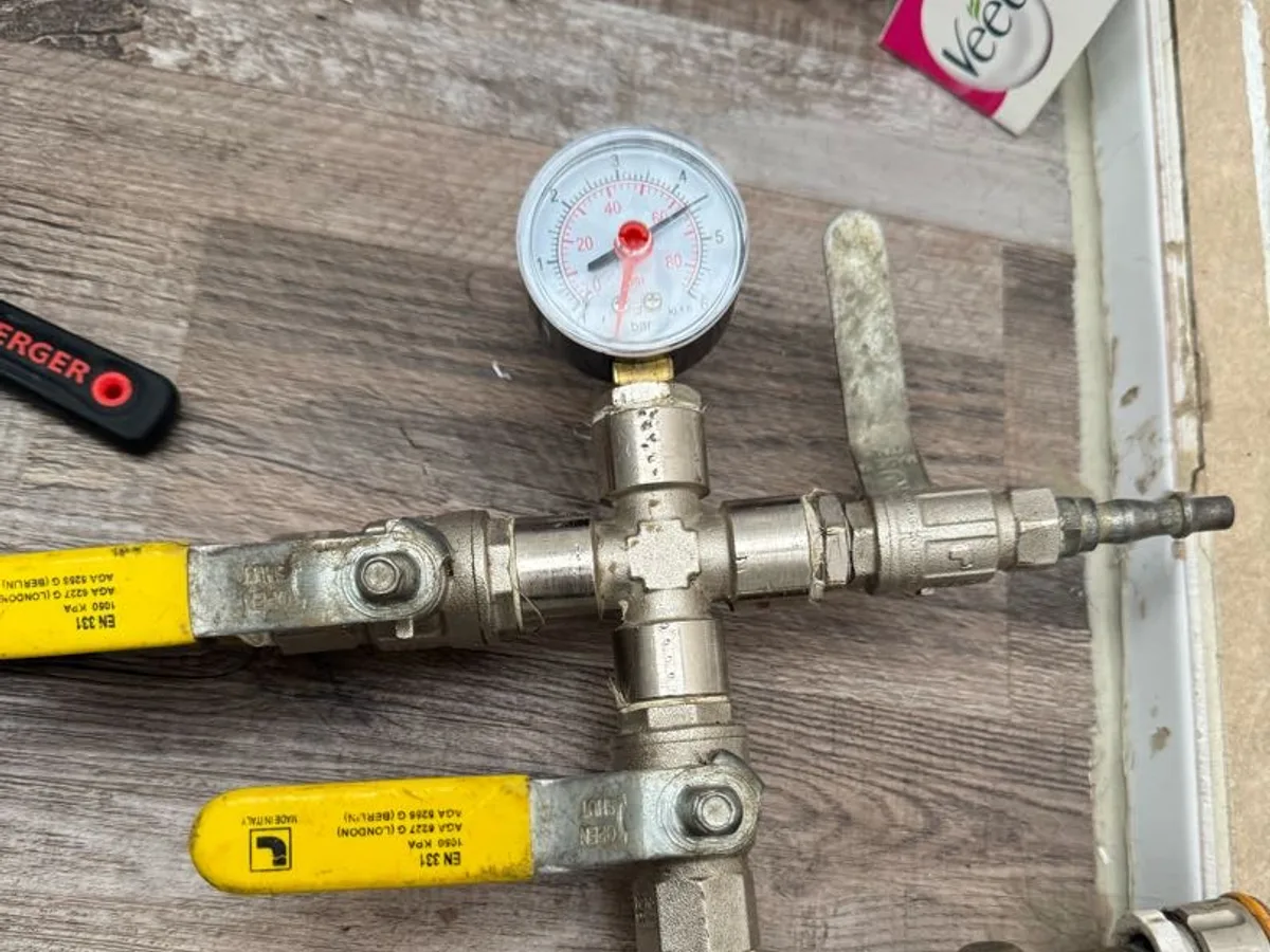 pressure test rig connected to hot water pipe during leak detection