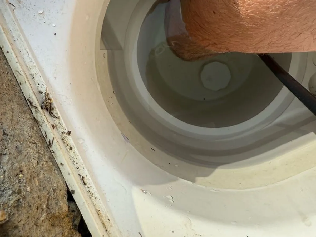 hydrophone probe inserted into skimmer pot opening during leak detection survey