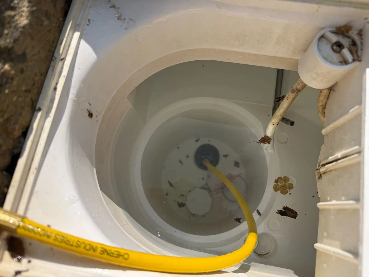 hydrophone probe lowered into water-filled skimmer pot during leak detection survey