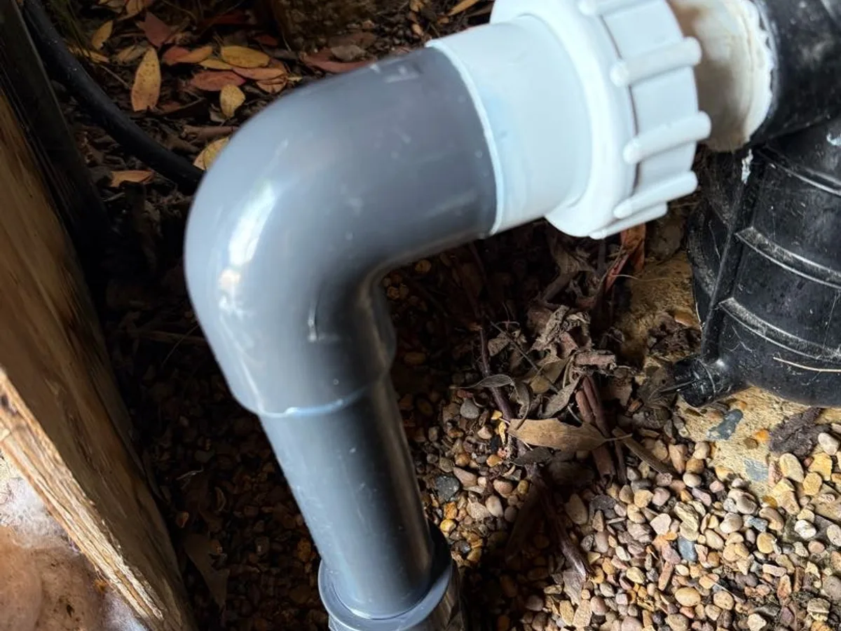 new PVC-U elbow and union fitting connecting to pool pump as repair completed