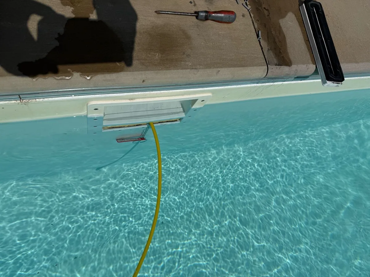 pressure gauge and fittings laid out for pool pipe pressure test during leak detection