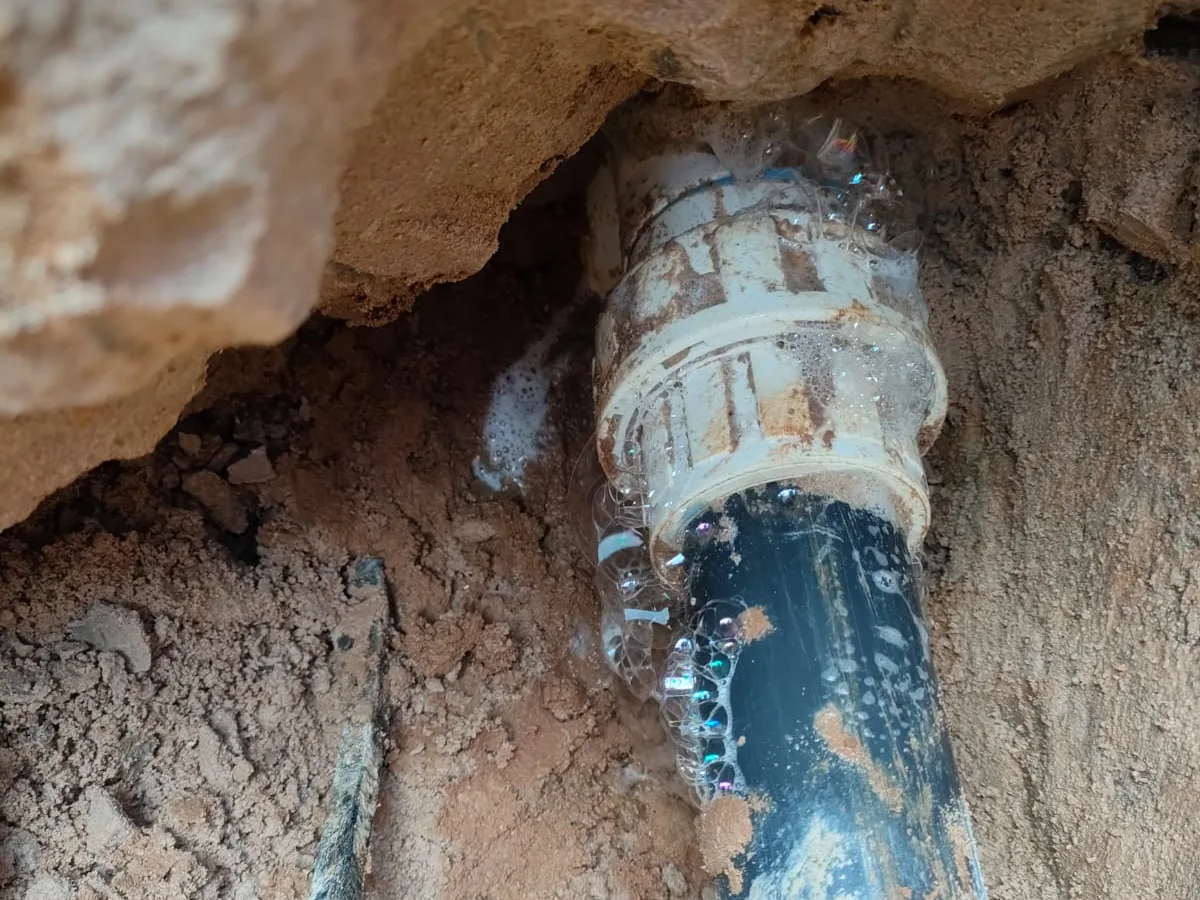 leak located at deteriorated union fitting on skimmer pipework exposed beneath concrete slab