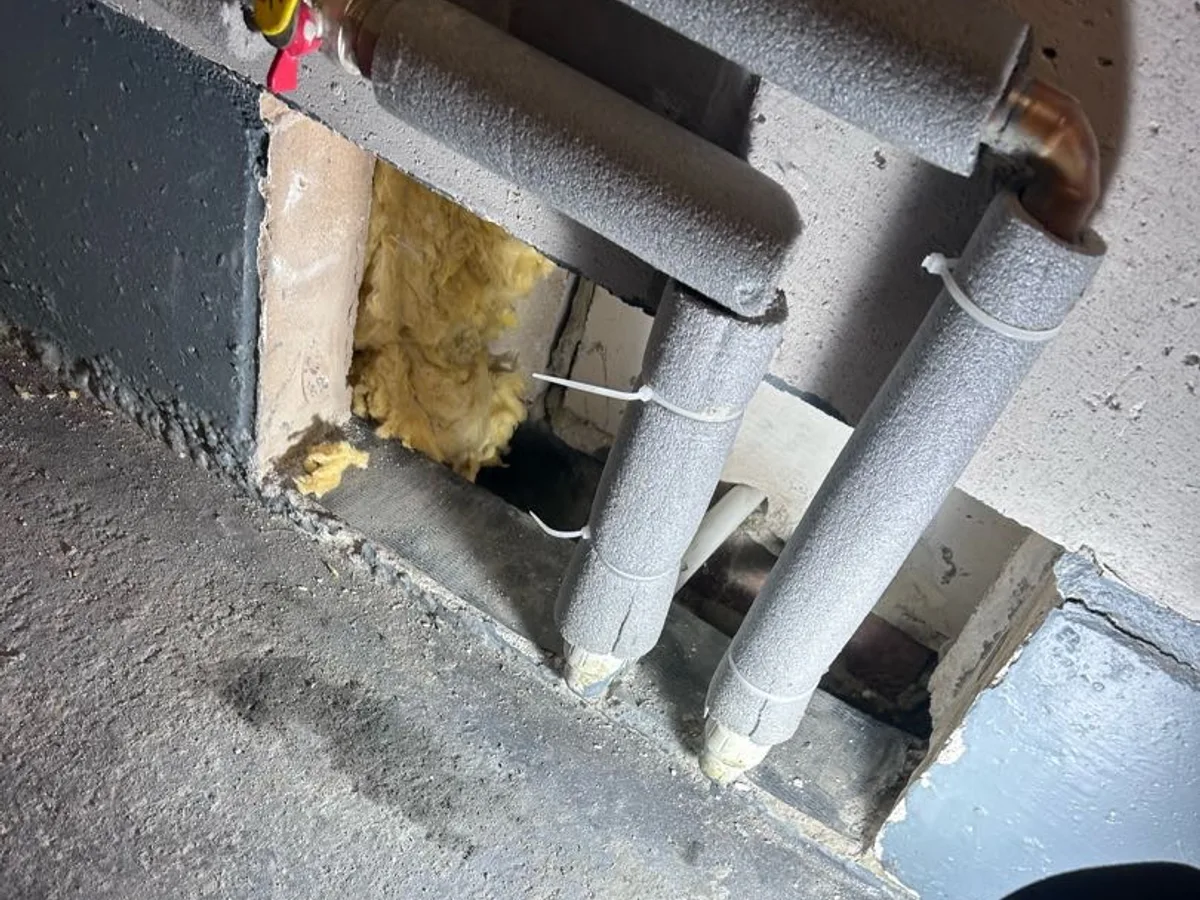 leak found at wall opening exposing wet insulation and underfloor heating pipework