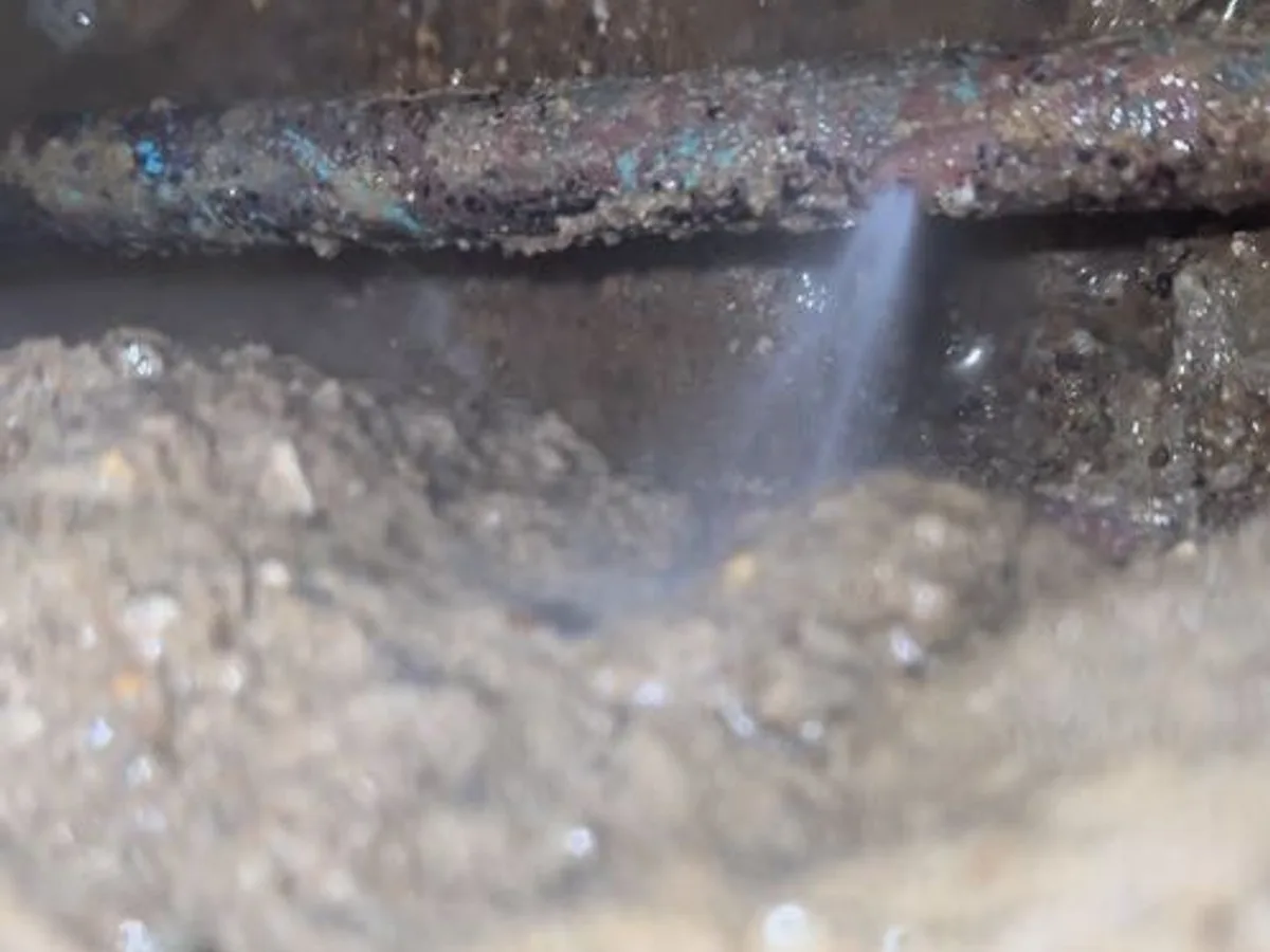 leak found at pinhole burst in heavily corroded cold mains copper pipe beneath concrete floor