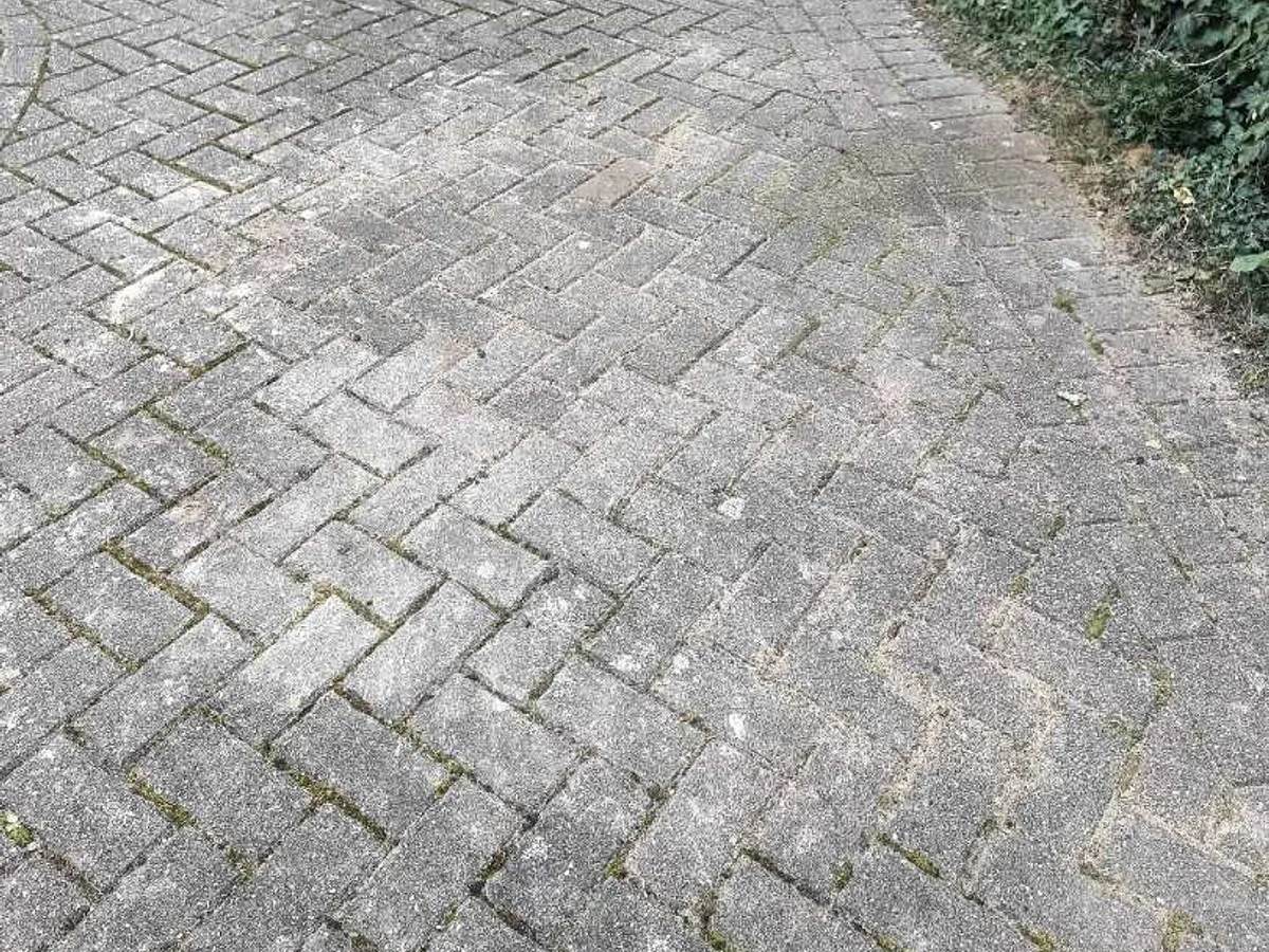 block paving driveway fully reinstated after underground mains leak repair works completed — reinstated after repair