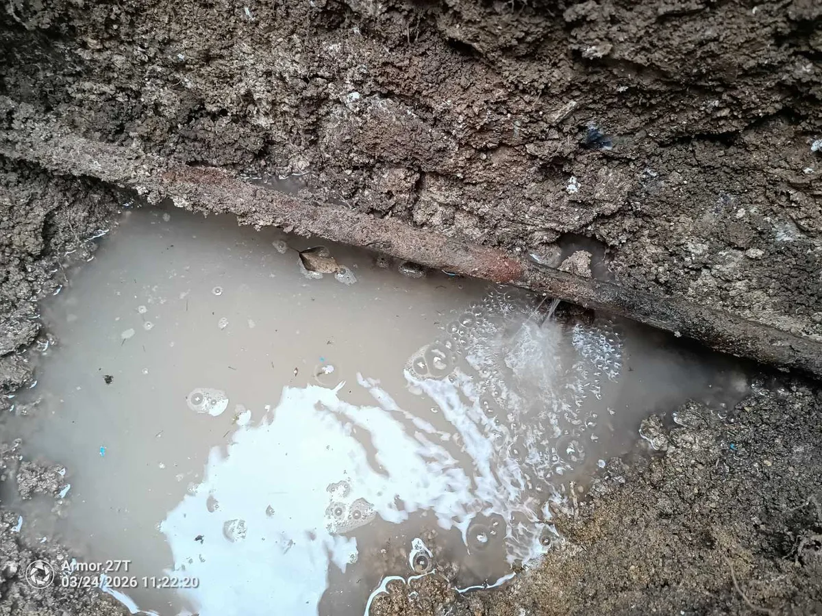 leak located at corroded 20mm metal mains pipe spraying water into excavated pit