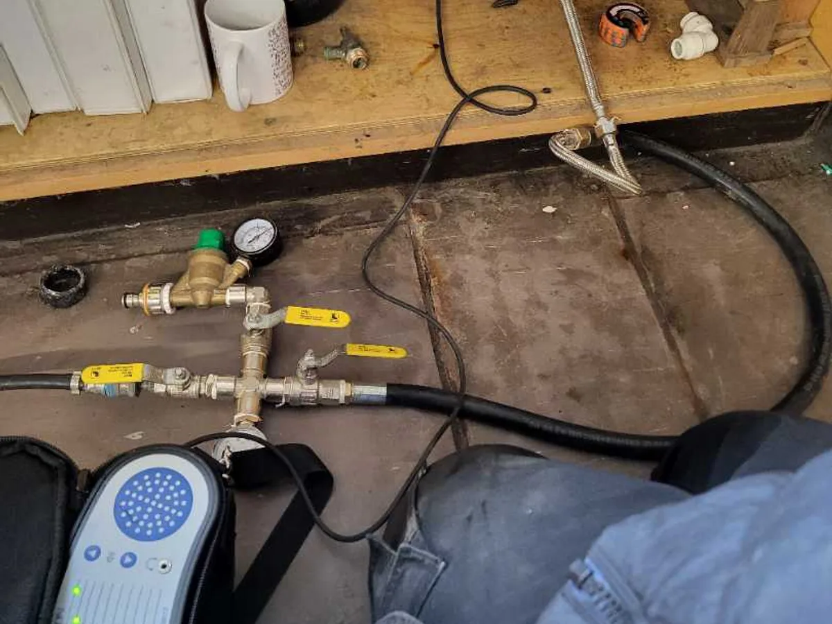 tracer gas injection rig with pressure gauge connected to pipework during leak detection