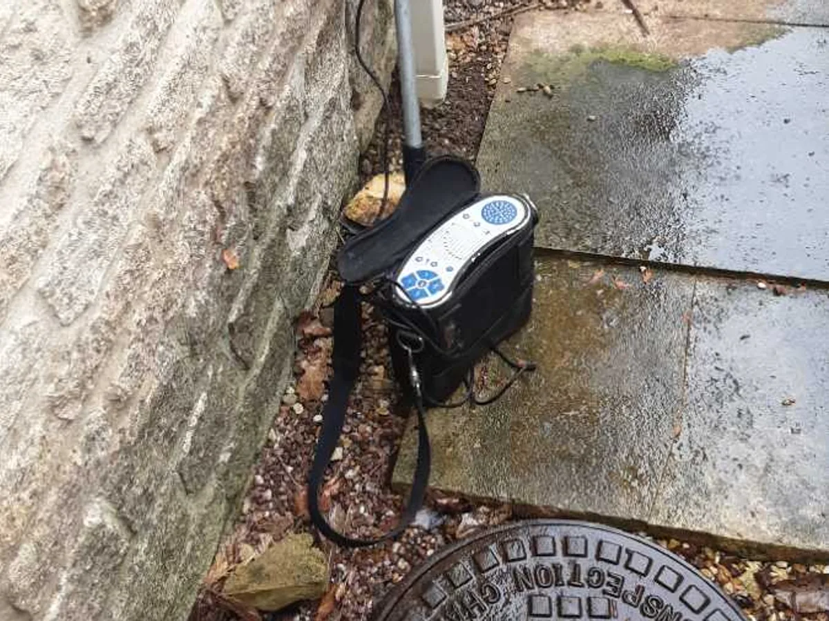 acoustic leak detection equipment probing side-of-property pathway during the survey