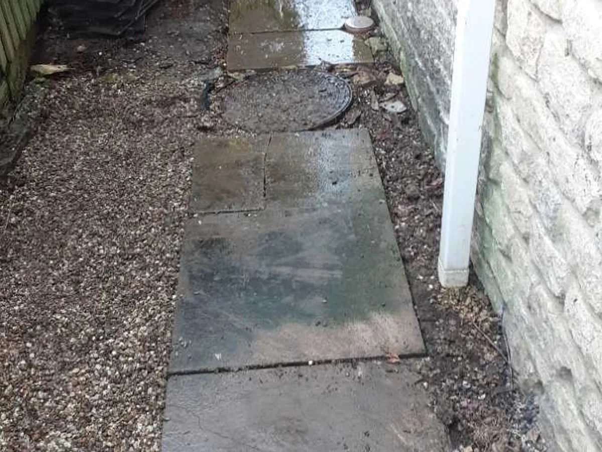 side-of-property stone slabs reinstated after repair to underground mains leak