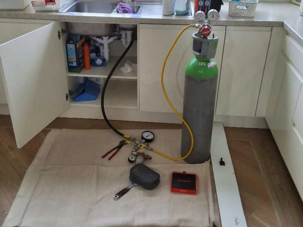 tracer gas cylinder connected to kitchen sink cold mains during leak detection survey