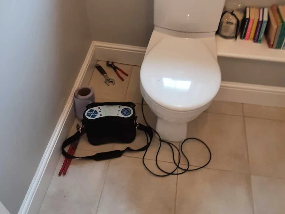 acoustic listening device placed on ground floor WC tiled floor during leak detection