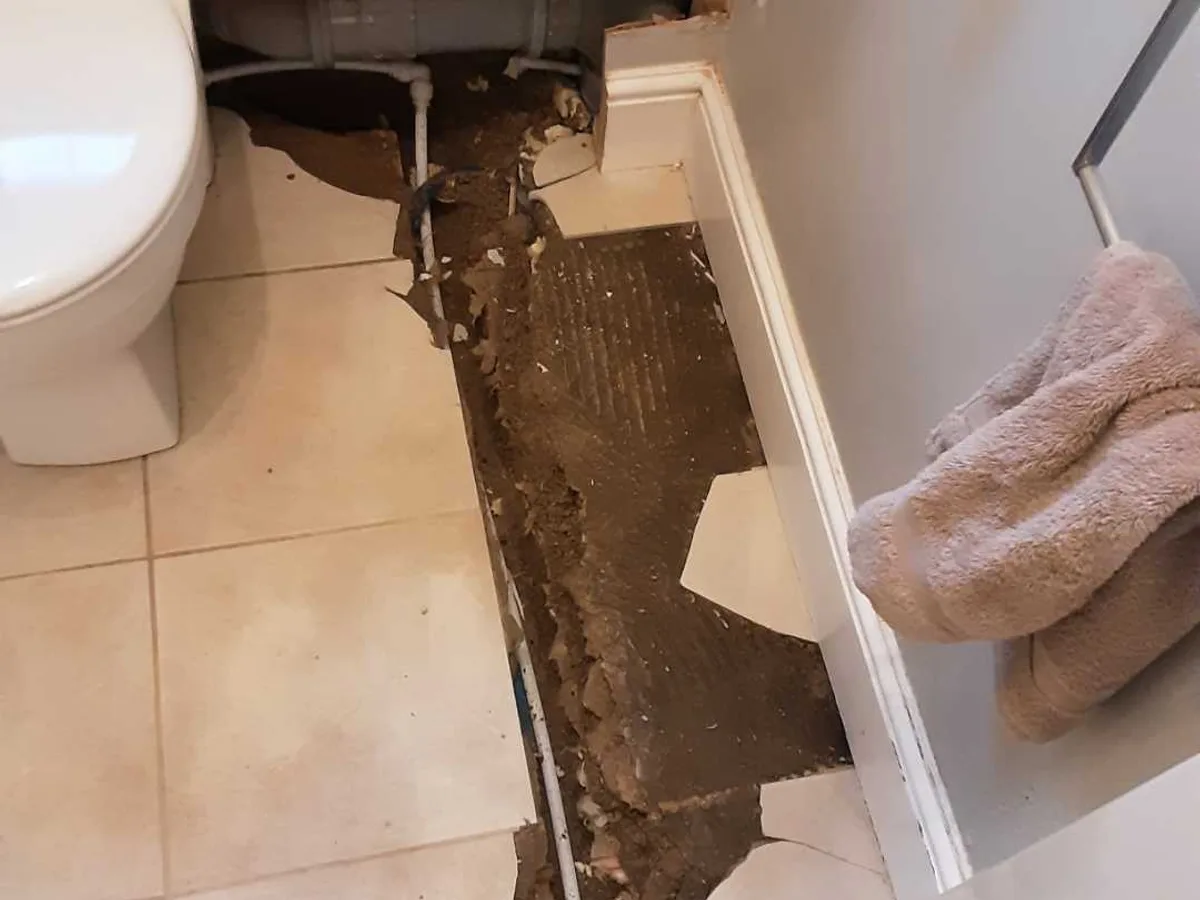 new push-fit pipework installed beneath ground floor WC tiles as repair in progress