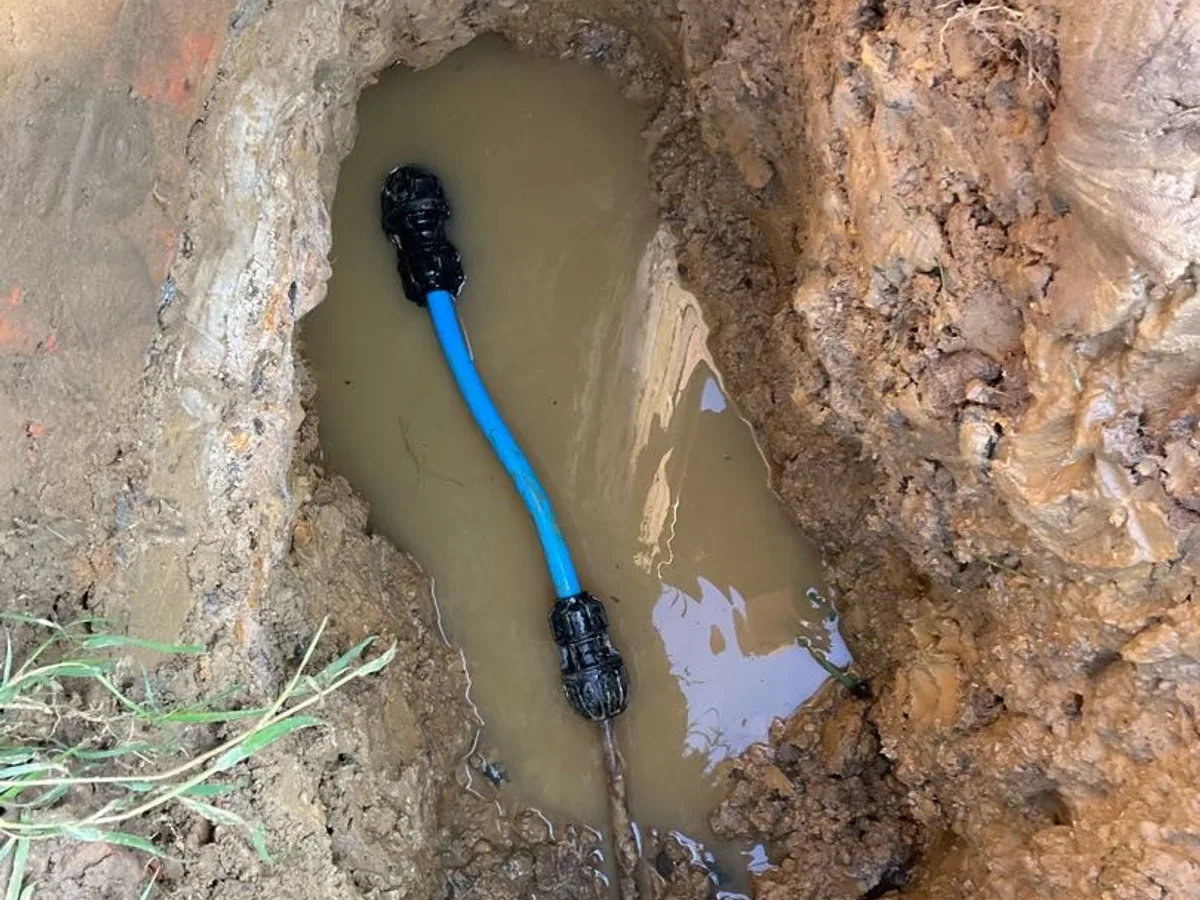 new 20mm blue MDPE water mains pipe with universal transition couplings repair completed in trench