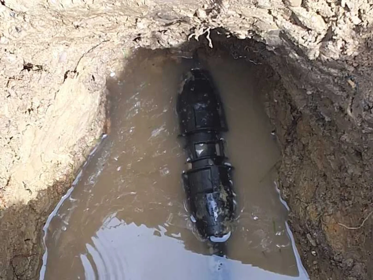 28mm transition coupling installed on alkathine cold mains as repair completed in excavation pit