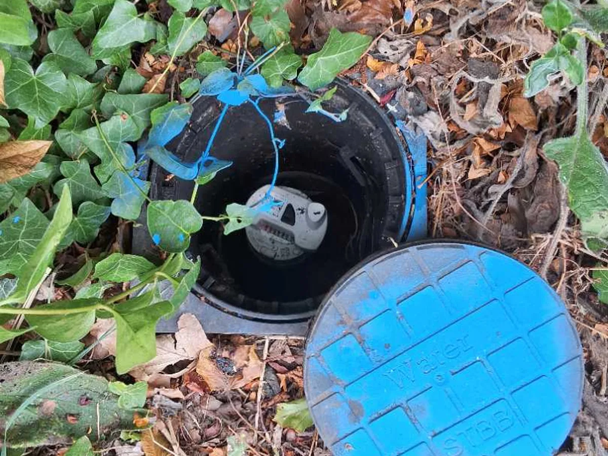 open water meter chamber with lid removed during leak detection flow test