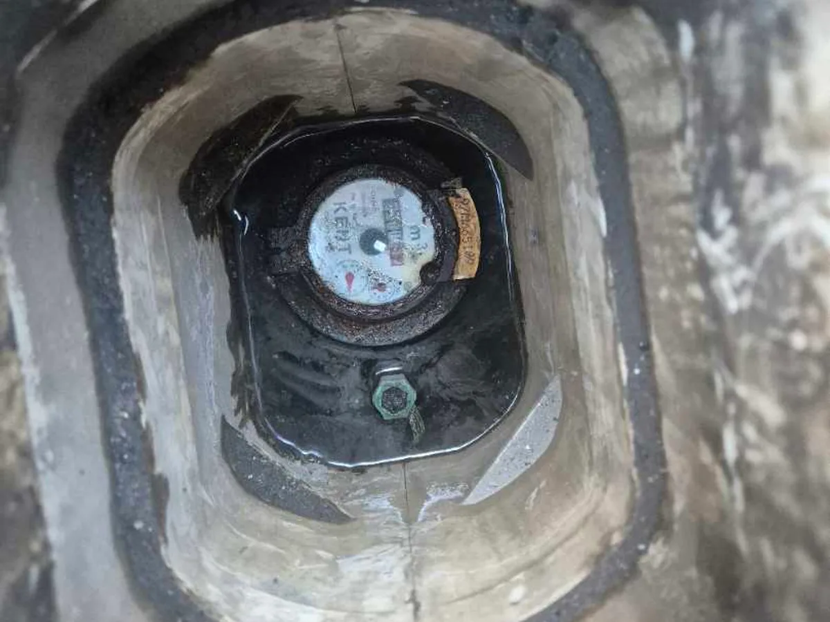 water meter inside underground chamber viewed from above during leak detection