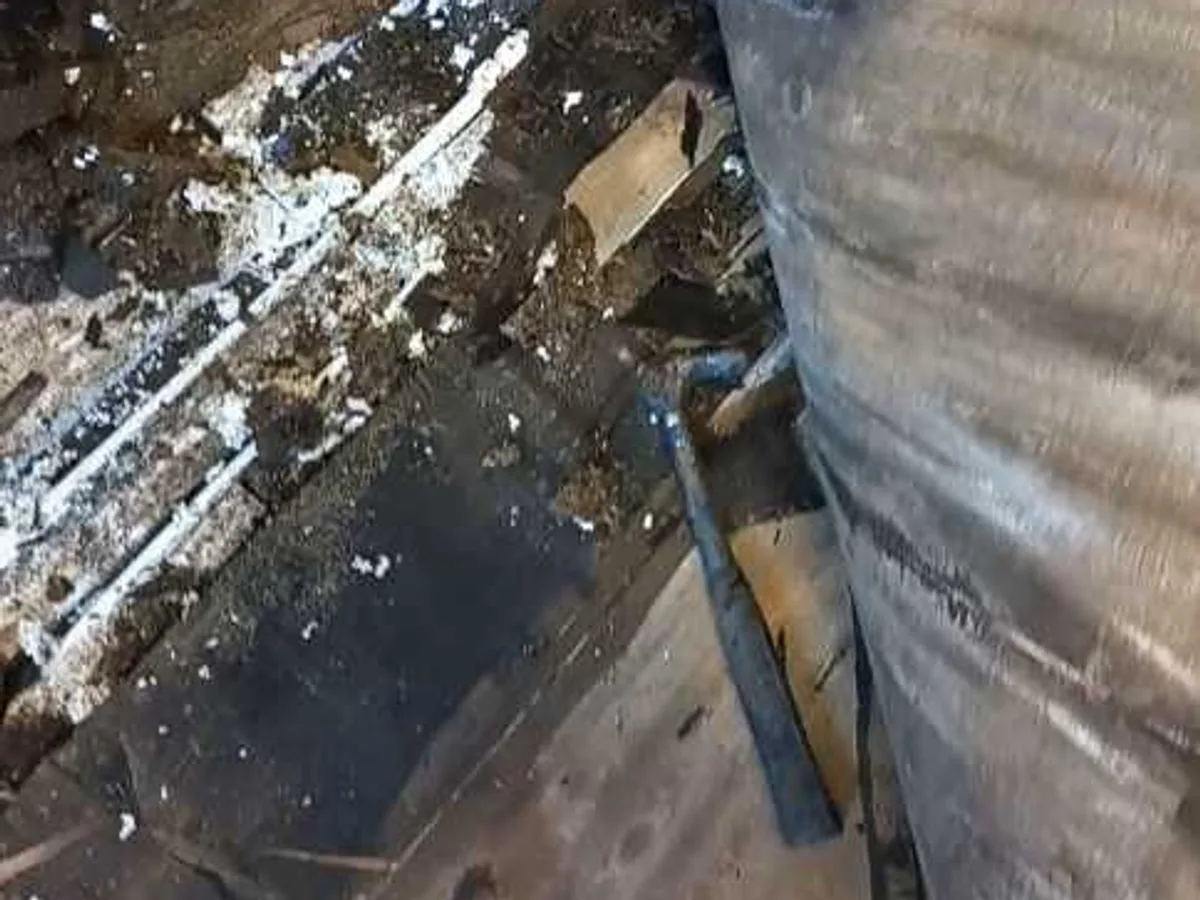leak exposed beneath kitchen floor showing saturated rotted subfloor timbers and standing water — leak located at