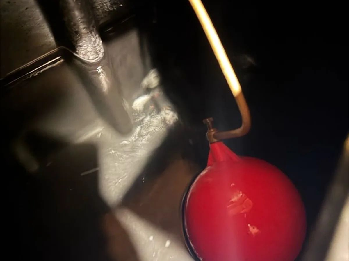 loft cold water tank with ball valve and pipework inspected during leak detection
