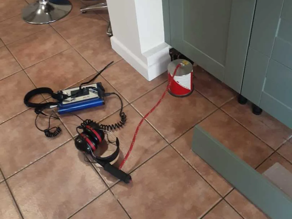 acoustic listening equipment and headset laid on kitchen floor during leak detection survey