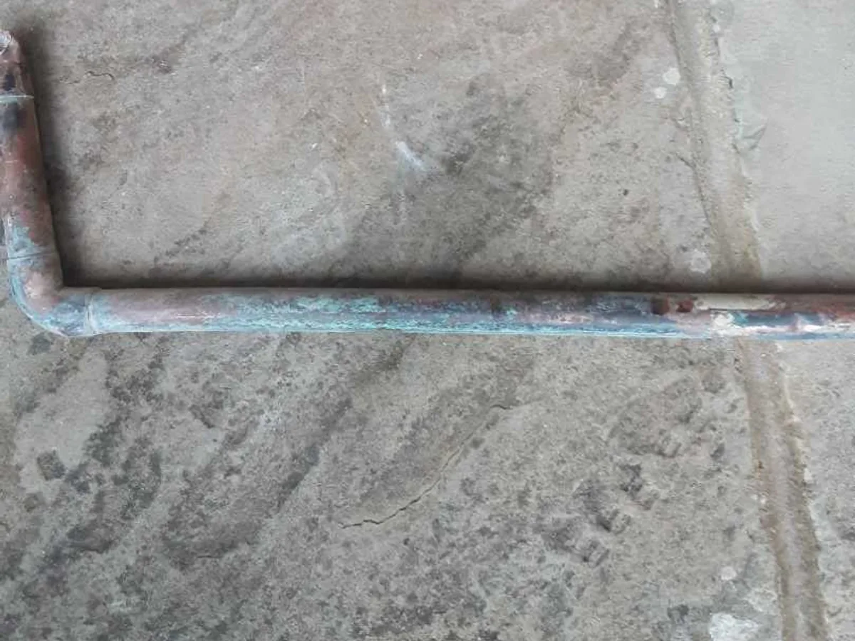 leak located at heavily corroded 22mm copper pipe section removed from concrete floor