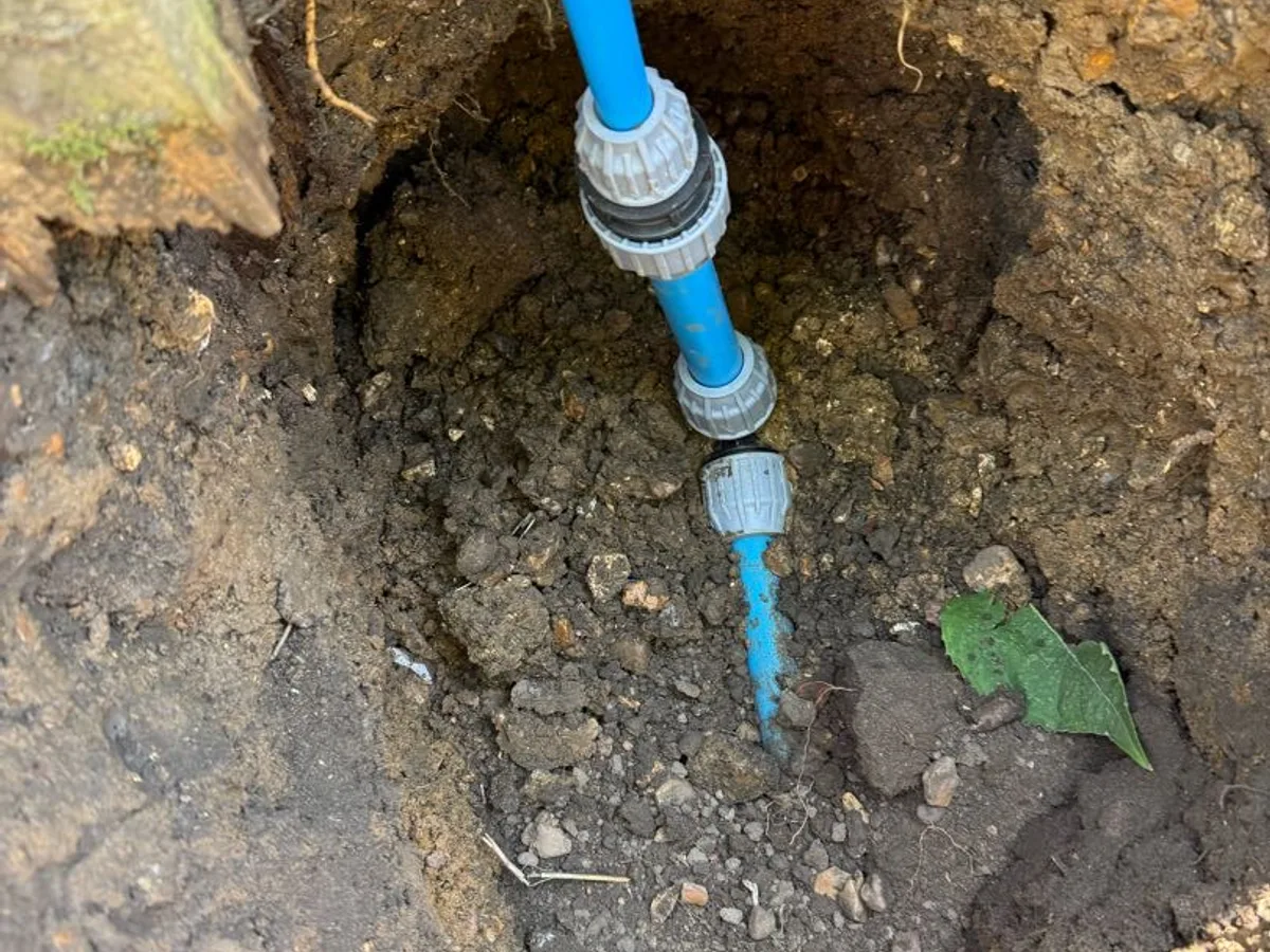 new plastic mains pipe with compression fittings installed as repair completed at allotment standpipe