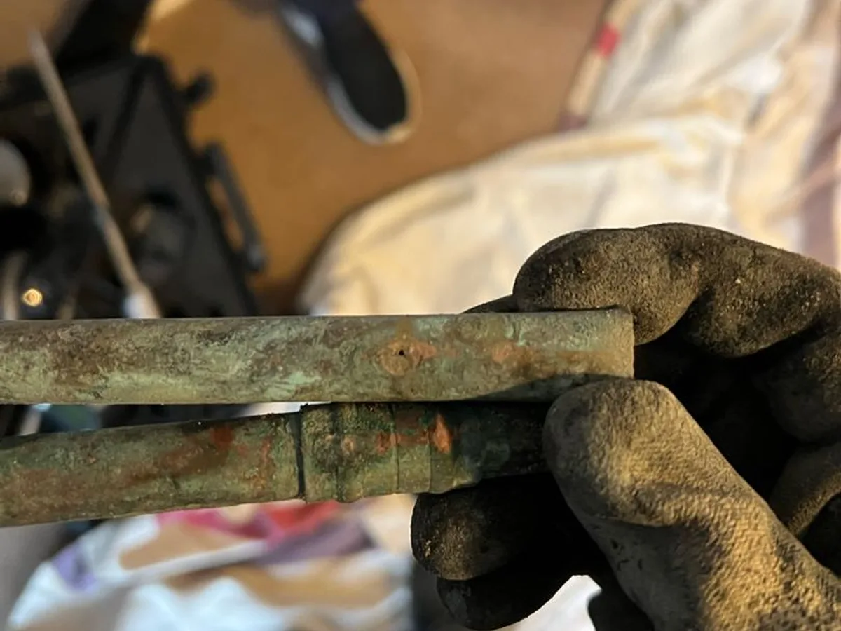 leak located at heavily corroded copper pipe sections removed from beneath concrete floor