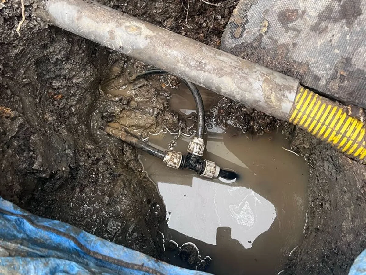 new compression tee fitting installed on underground mains pipework as repair completed
