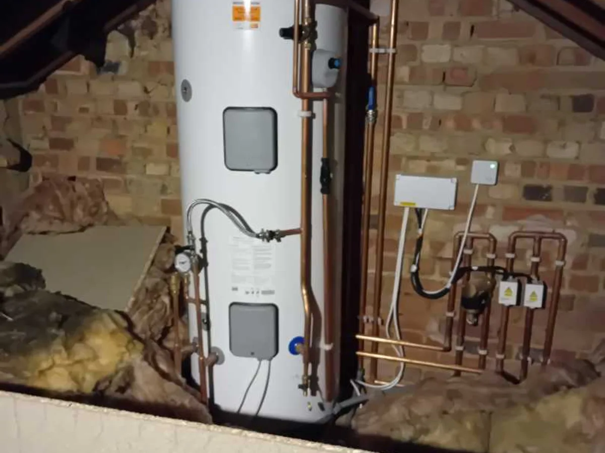unvented hot water cylinder and copper pipework in loft space during leak detection survey