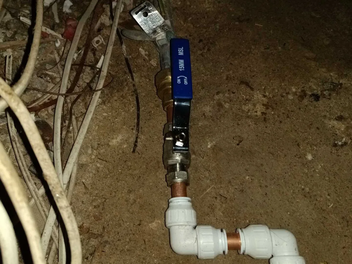 fault identified at incorrectly installed copper stop valve beneath staircase before lead pipework — leak located at