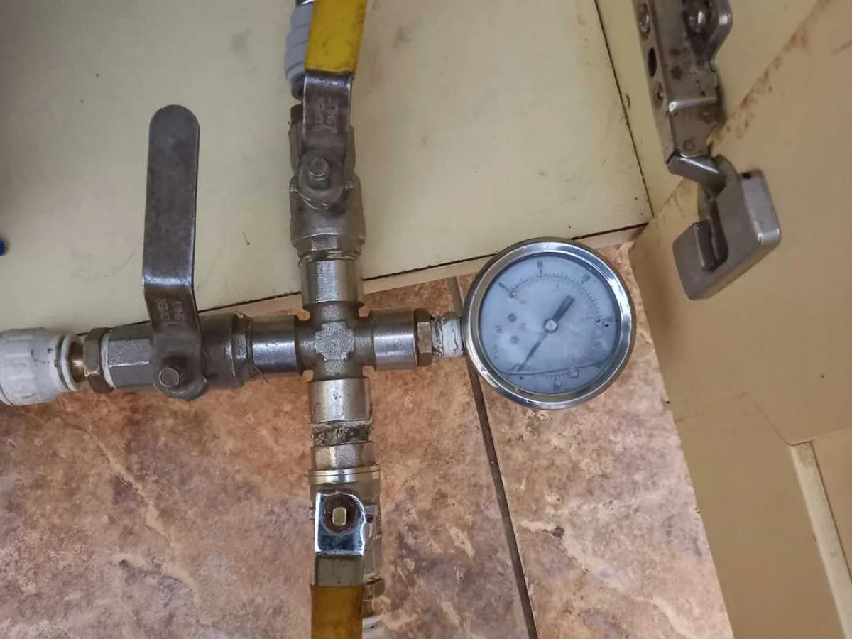 pressure test rig with gauge connected to supply pipework during leak detection