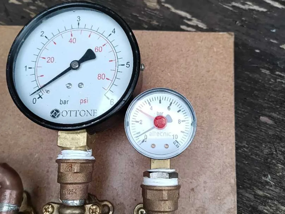 two pressure gauges on test rig close up during leak detection survey