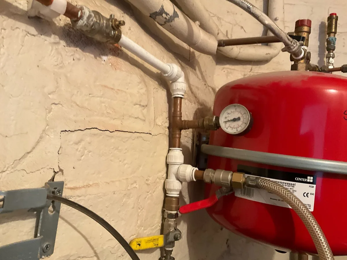 pressure gauge on expansion vessel in boiler room during leak detection survey