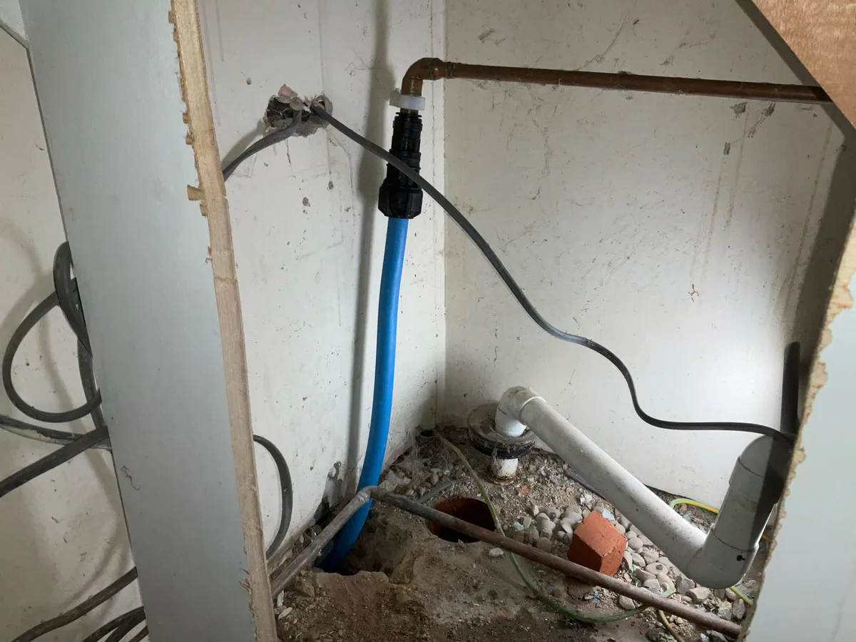 fault exposed at MDPE blue water mains pipe entering building beneath concrete screed