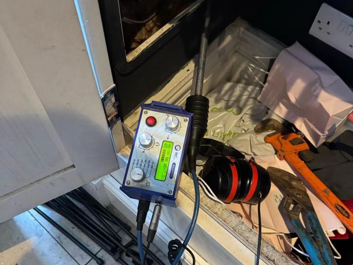 acoustic leak detection unit with headphones in use during investigation