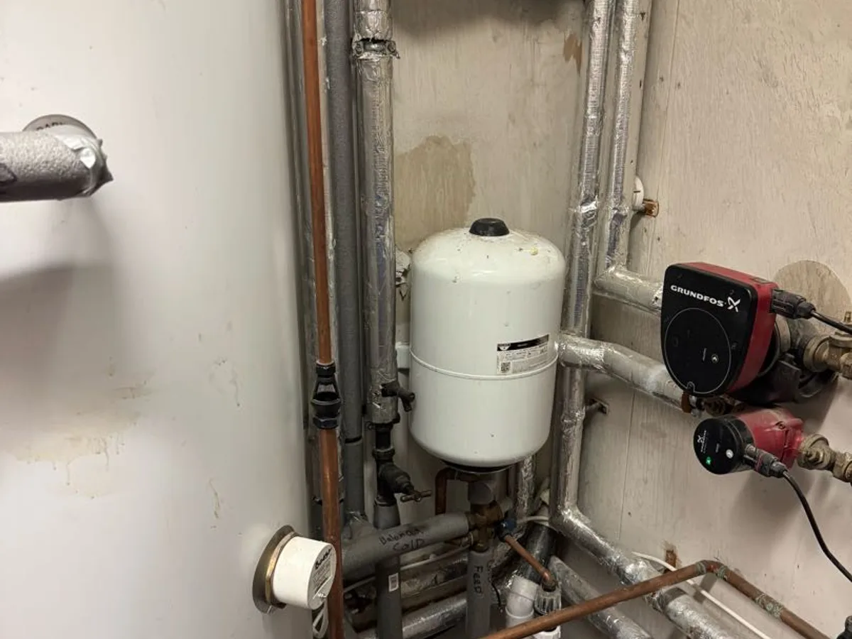 plant room pipework with expansion vessel and circulation pump during leak detection