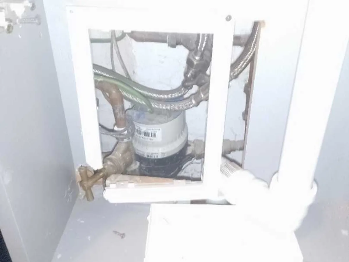 internal stopcock and water meter accessed through panel during leak detection investigation