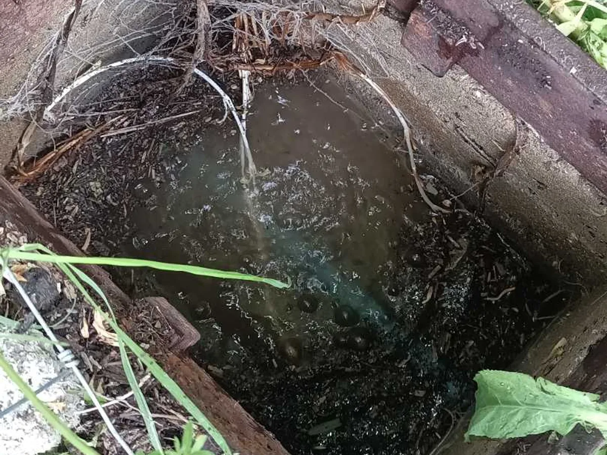 leak found at waterlogged underground chamber with debris and standing water