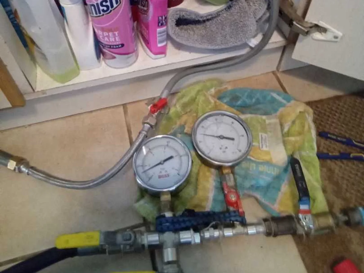 pressure test manifold with dual gauges connected to cold feed pipework during leak detection