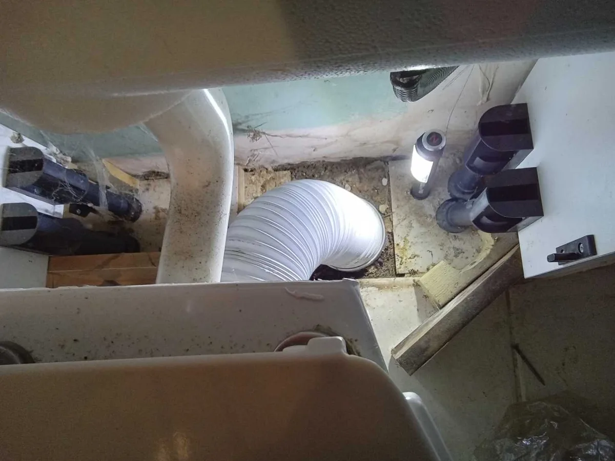 new flexible pan connector installed beneath toilet as repair completed