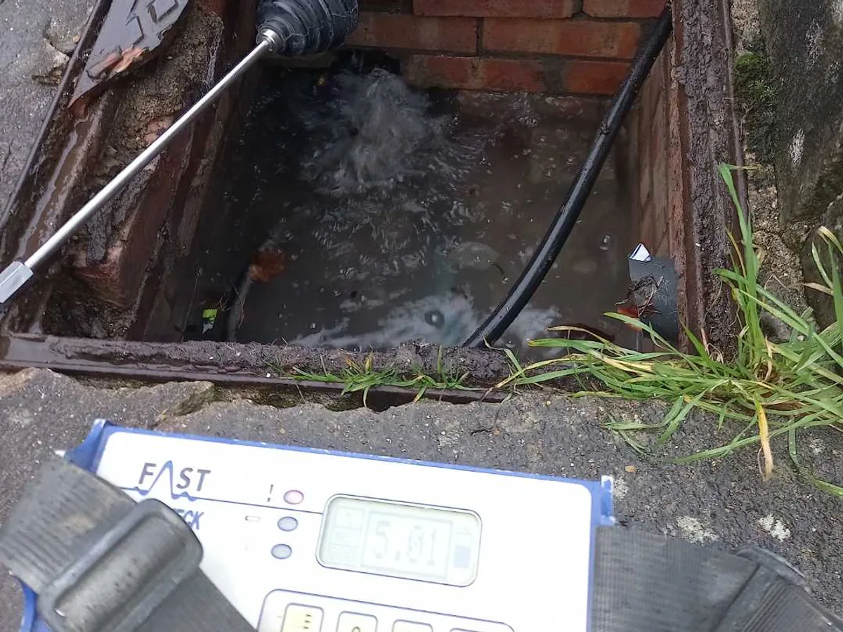 leak found at water-filled access chamber with acoustic listening probe and tracer gas detector reading
